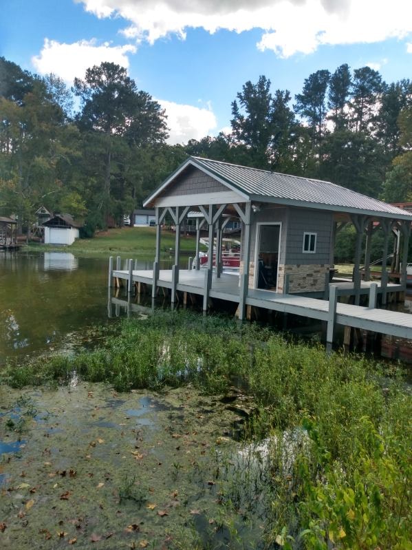 SHT Construction — completed boathouse exterior on the water