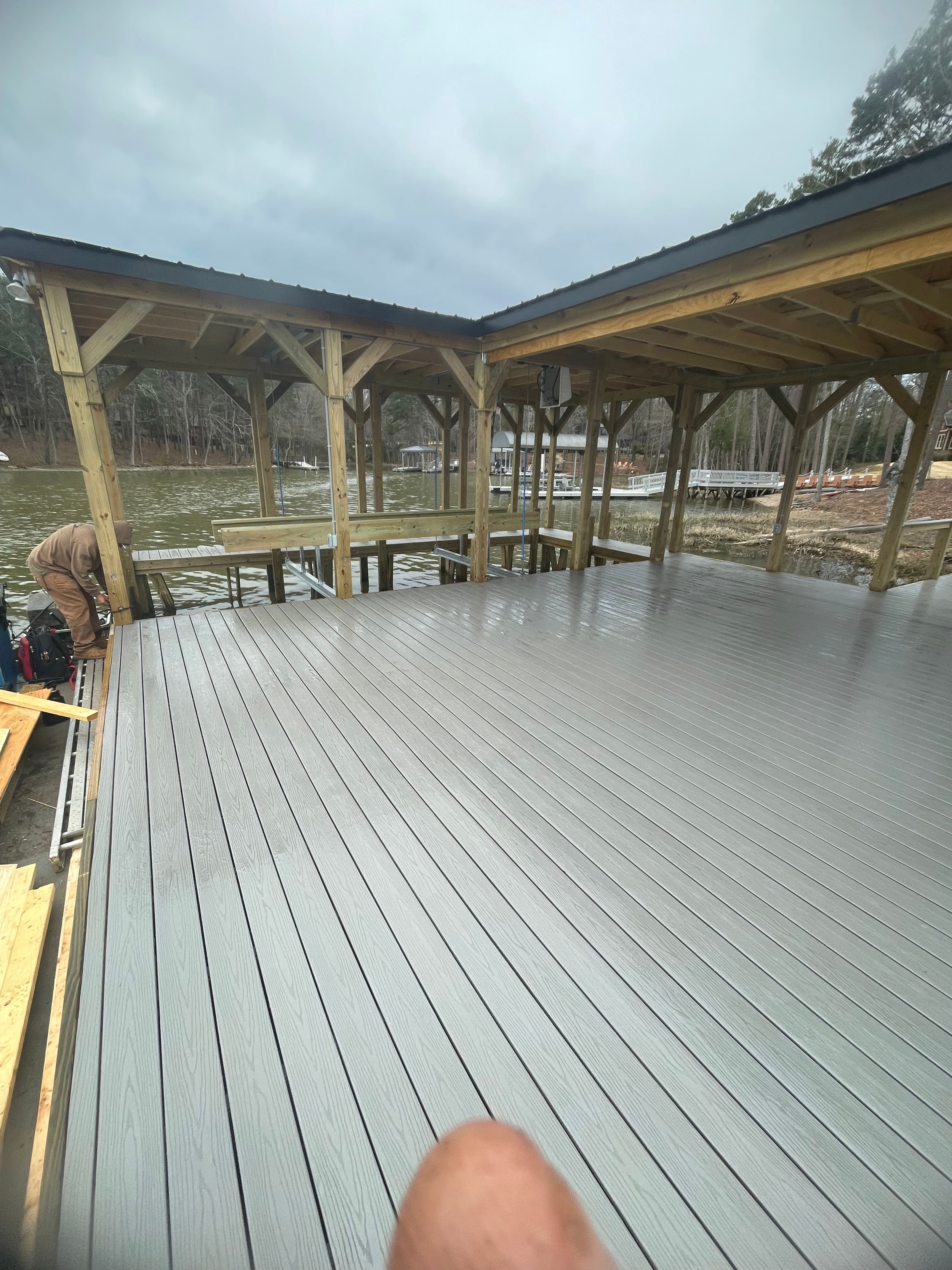 SHT Construction — boathouse framing with gray composite siding under construction